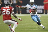 HOUSTON - NOVEMBER 23:  Running Back Chris Johnson #28 of the Tennessee Titans carries the ball against safety Eugene Wilson #26 of the Houston Texans on November 23, 2009  at Reliant Stadium in Houston, Texas.  The Titans won 20-17.  (Photo by Stephen Dunn/Getty Images)