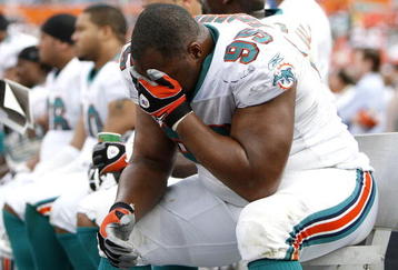 MIAMI - JANUARY 04:  Jason Ferguson #95 of the Miami Dolphins sits on the bench during the final minuets of their 27-9 AFC Wild Card loss to the Baltimore Ravens on January 4, 2009 at Dolphin Stadium in Miami, Florida.  (Photo by Gregory Shamus/Getty Images)