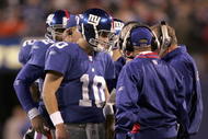 EAST RUTHERFORD, NJ - OCTOBER 23:  Quarterback Eli Manning #10 of the New York Giants talks with coaching staff during a time out before the last play of the game against the Denver Broncos on October 23, 2005 at Giants Stadium in East Rutherford, New Jersey. The Giants defeated the Broncos 24-23.  (Photo by Nick Laham/Getty Images)