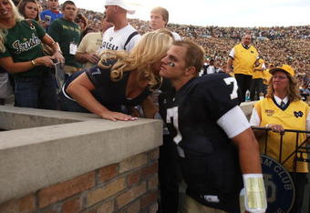 SOUTH BEND, IN - SEPTEMBER 19: Jimmy Clausen #7 of the Notre Dame Fighting Irish gets a hug from a relative after a win over the Michigan State Spartans on September 19, 2009 at Notre Dame Stadium in South Bend, Indiana. Notre Dame defeated Michigan State 33-30. (Photo by Jonathan Daniel/Getty Images)