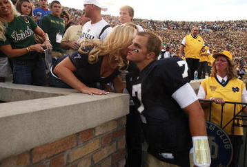 SOUTH BEND, IN - SEPTEMBER 19: Jimmy Clausen #7 of the Notre Dame Fighting Irish gets a hug from a relative after a win over the Michigan State Spartans on September 19, 2009 at Notre Dame Stadium in South Bend, Indiana. Notre Dame defeated Michigan State 33-30. (Photo by Jonathan Daniel/Getty Images)