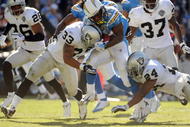 SAN DIEGO - NOVEMBER 01: Darren Sproles #43 of the San Diego Chargers gets hit by Tyvon Branch #33 and Michael Huff #24 of the Oakland Raiders during the game at Qualcomm Stadium on November 1, 2009 in San Diego California. The Chargers defeated the Raiders 24-16. (Photo by Harry How/Getty Images)