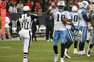 HOUSTON - NOVEMBER 23: Quarterback Vince Young #10 of the Tennessee Titans high fives with referee Jerome Boger at the end of the game with the Houston Texans on November 23, 2009 at Reliant Stadium in Houston, Texas. (Photo by Stephen Dunn/Getty Images)