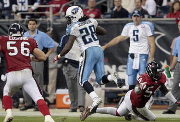 HOUSTON - NOVEMBER 23:  Running back Chris Johnson #28 of the Tennessee Titans rushes past linebacker Zac Diles #54 of the Houston Texans and Brian Cushing #56 in the second quarter at Reliant Stadium on November 23, 2009 in Houston, Texas.  (Photo by Bob Levey/Getty Images)