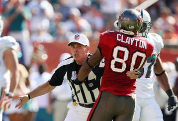 MIAMI GARDENS, FL - NOVEMBER 15:  Referee Tony Corrente #99 tries to seperate wide receiver Michael Clayton #80 of the Tampa Bay Buccaneers from getting into a fight with Dolphin players while taking on the Miami Dolphins at Land Shark Stadium on November 15, 2009 in Miami Gardens, Florida.  (Photo by Doug Benc/Getty Images)