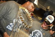 NEW YORK - NOVEMBER 04:  C.C. Sabathia (L) and A.J. Burnett of the New York Yankees celebrate in the locker room with the trophy after their 7-3 win against the Philadelphia Phillies in Game Six of the 2009 MLB World Series at Yankee Stadium on November 4, 2009 in the Bronx borough of New York City.  (Photo by Nick Laham/Getty Images)