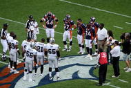 DENVER - SEPTEMBER 16:  Referee Walt Anderson conducts the coin toss between the Raiders and the Broncos as the Denver Broncos defeated the Oakland Raiders 23-20 in overtime during week two NFL action at Invesco Field at Mile High on September 16, 2007 in Denver, Colorado.  (Photo by Doug Pensinger/Getty Images)