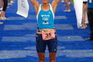 PORT MACQUARIE, AUSTRALIA - APRIL 05: Chrissie Wellington of the United Kingdom celebrates being the first placed woman in the 2009 Ironman Australia on April 5, 2009 in Port Macquarie, Australia. (Photo by Cameron Spencer/Getty Images)