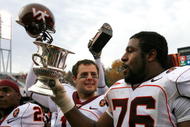 CHARLOTTESVILLE, VA - NOVEMBER 24:  Tackle Duane Brown #76 of the Virginia Tech Hokies celebrates with the Commonwealth Cup after defeating the Virginia Cavaliers 33-21 at Scott Stadium on November 24, 2007 in Charlottesville, Virginia.  (Photo by Kevin C. Cox/Getty Images)