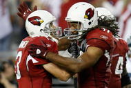 GLENDALE, AZ - NOVEMBER 15:  Kurt Warner (L) ) #13 of the Arizona Cardinals celebrates a touchdown with Larry Fitzgerald #11 in the second half against the Seattle Seahawks at University of Phoenix Stadium on November 15, 2009 in Glendale, Arizona. The Cardinals defeated the Seahawks 31-20.  (Photo by Jeff Gross/Getty Images)