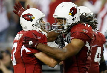 GLENDALE, AZ - NOVEMBER 15:  Kurt Warner (L) ) #13 of the Arizona Cardinals celebrates a touchdown with Larry Fitzgerald #11 in the second half against the Seattle Seahawks at University of Phoenix Stadium on November 15, 2009 in Glendale, Arizona. The Cardinals defeated the Seahawks 31-20.  (Photo by Jeff Gross/Getty Images)