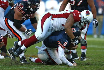 CHICAGO - NOVEMBER 08: Jay Cutler #6 of the Chicago Bears is sacked by Will Davis #59 and flattened by Alan Branch #78 of the Arizona Cardinals at Soldier Field on November 8, 2009 in Chicago, Illinois. The Cardinals defeated the Bears 41-21.  (Photo by Jonathan Daniel/Getty Images)