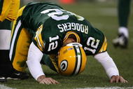 GREEN BAY, WI - NOVEMBER 15: Aaron Rodgers #12 of the Green Bay Packers is slow to get up after being hit during a game against the Dallas Cowboys at Lambeau Field on November 15, 2009 in Green Bay, Wisconsin. The Packers defeated the Cowboys 17-7.  (Photo by Jonathan Daniel/Getty Images)