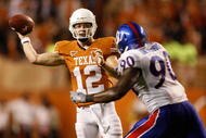 AUSTIN, TX - NOVEMBER 21: Quarterback Colt McCoy #12 of the Texas Longhorns drops back to pass against Maxwell Onyegbule #90 of the Kansas Jayhawks at Darrell K Royal-Texas Memorial Stadium on November 21, 2009 in Austin, Texas. (Photo by Ronald Martinez/Getty Images)