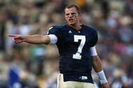 SOUTH BEND, IN - SETPEMBER 19: Jimmy Clausen #7 of the Notre Dame Fighting Irish congratulates teammates after an extra point against the Michigan State Spartans on September 19, 2009 at Notre Dame Stadium in South Bend, Indiana. Notre Dame defeated Michigan State 33-30. (Photo by Jonathan Daniel/Getty Images)
