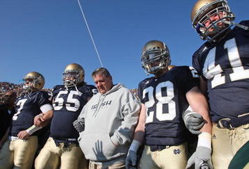 SOUTH BEND, IN - NOVEMBER 21: Head coach Charlie Weis of the Notre Dame Fighting Irish waits to enter the field with (L-R) Jimmy Clausen #7, Eric Olsen #55, Kyle McCarthy #28 and Scott Smith #41 before a game against the University of Connecticut Huskies at Notre Dame Stadium on November 21, 2009 in South Bend, Indiana. (Photo by Jonathan Daniel/Getty Images)
