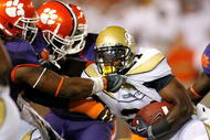 ATLANTA - SEPTEMBER 10: Da'Quan Bowers #93 and Brandon Thompson #98 of the Clemson Tigers tackle Jonathan Dwyer #21 of the Georgia Tech Yellow Jackets at Bobby Dodd Stadium on September 10, 2009 in Atlanta, Georgia. (Photo by Kevin C. Cox/Getty Images)