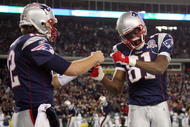 FOXBORO, MA - NOVEMBER 22:  Randy Moss #81 and Tom Brady #12 of the New England Patriots celebrate Laurence Maroney's touchdown in the second quarter against the New York Jets on November 22, 2009 at Gillette Stadium in Foxboro, Massachusetts.  (Photo by Elsa/Getty Images)