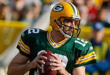 GREEN BAY, WI - NOVEMBER 22: Quarterback Aaron Rodgers #12 of the Green Bay Packers passes the football against the San Francisco 49ers at Lambeau Field on November 22, 2009 in Green Bay, Wisconsin. The Packers defeated the 49ers 30-24. (Photo by Scott Boehm/Getty Images)