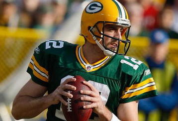 GREEN BAY, WI - NOVEMBER 22: Quarterback Aaron Rodgers #12 of the Green Bay Packers passes the football against the San Francisco 49ers at Lambeau Field on November 22, 2009 in Green Bay, Wisconsin. The Packers defeated the 49ers 30-24. (Photo by Scott Boehm/Getty Images)