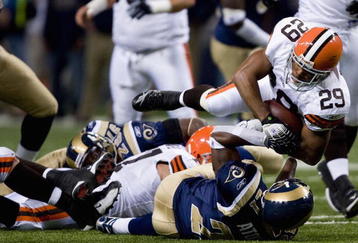 ST. LOUIS - OCTOBER 28:  Oshiomogho Atogwe #21 of the St. Louis Rams tackles Jason Wright #29 of the Cleveland Browns at the Edward Jones Dome October 28, 2007 in St. Louis, Missouri. The Browns beat the Rams 27-20.  (Photo by Dilip Vishwanat/Getty Images)