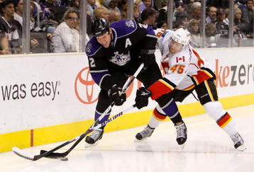 LOS ANGELES, CA - NOVEMBER 21:  Matt Greene #2 of the Los Angeles Kings and Jamie Lundmark #45 of the Calgary Flames battle for the puck along the boards in the third period at Staples Center on November 21, 2009 in Los Angeles, California. The Flames defeated the Kings 5-2.  (Photo by Jeff Gross/Getty Images)