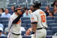 NEW YORK - JULY 20: Nick Markakis #21 of the Baltimore Orioles celebrates his home run against the New York Yankees with teammate Adam Jones #10 on July 20, 2009 at Yankee Stadium in the Bronx borough of New York City. (Photo by Jim McIsaac/Getty Images)