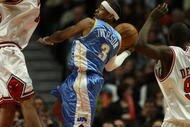 CHICAGO - FEBRUARY 22: Allen iverson #3 of the Denver Nuggets leaps to pass the ball between Joakim Noah #13 (L) and Luol Deng #9 of the Chicago Bulls on February 22, 2008 at the United Center in Chicago, Illinois. NOTE TO USER: User expressly acknowledges and agreees that, by downloading and/or using this Photograph, User is consenting to the terms and conditions of the Getty Images License Agreement. (Photo by Jonathan Daniel/Getty Images)