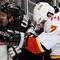 ANAHEIM, CA - NOVEMBER 23:  Kyle Calder #32 of the Anaheim Ducks is checked against the glass by Adam Pardy #7 of the Calgary Flames during the first period of the NHL game at the Honda Center on November 23, 2009 in Anaheim, California.  (Photo by Kevork Djansezian/Getty Images)