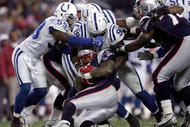 FOXBORO, MA - NOVEMBER 05: Cato June #59 and Robert Mathis #98 of the Indianapolis Colts tackle Corey Dillon #28 of the New England Patriots at Gillette Stadium on November 5, 2006 in Foxboro, Massachusetts.  (Photo by Elsa/Getty Images)