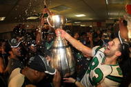 TORONTO, ON - NOVEMBER 25: Andy Fantuz #83 of the Saskatchewan Rough Riders hoist the trophy amongst champagne in celebration of a victory over the Winnipeg Blue Bombers during the 95th Grey Cup on November 25, 2007 at the Rogers Centre in Toronto, Ontario, Canada. (Photo by Harry How/Getty Images)