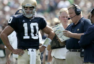 SOUTH BEND, IN - SEPTEMBER 9:  Brady Quinn #10 of the Notre Dame Fighting Irish talks with head coach Charlie Weis during a game against the Penn State Nittany Lions on September 9, 2006 at Notre Dame Stadium in South Bend, Indiana. Notre Dame won the game 41-17. (Photo By Gregory Shamus/Getty Images)  