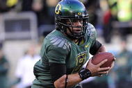 EUGENE, OR - OCTOBER 31: Quarterback Jeremiah Masoli #8 of the Oregon Ducks tucks the ball and heads upfield in the second quarter of the game against the USC Trojans at Autzen Stadium on October 31, 2009 in Eugene, Oregon. Masoli threw for 222 yards and a touchdown and ran for 164 more yards with another score as Oregon defeated USC 47-20. (Photo by Steve Dykes/Getty Images)