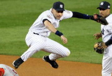 NEW YORK - NOVEMBER 04:  Derek Jeter #2 of the New York Yankees turns a successful double play over Shane Victorino #8 of the Philadelphia Phillies in the top of the first inning of Game Six of the 2009 MLB World Series at Yankee Stadium on November 4, 2009 in the Bronx borough of New York City. The Yankees won 7-3 to win the series 4 games to 2. (Photo by Al Bello/Getty Images)