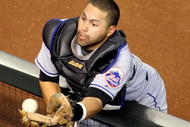 PHOENIX - AUGUST 12: Catcher Omir Santos #9 of the New York Mets is unable to catch a foul ball as a fan interferes during a Major League Baseball game against the Arizona Diamondbacks at Chase Field on August 12, 2009 in Phoenix, Arizona. (Photo by Christian Petersen/Getty Images)e