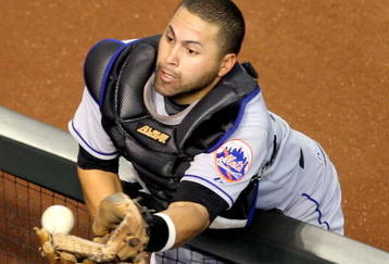 PHOENIX - AUGUST 12:  Catcher Omir Santos #9 of the New York Mets is unable to catch a foul ball as a fan interferes during a Major League Baseball game against the Arizona Diamondbacks at Chase Field on August 12, 2009 in Phoenix, Arizona.  (Photo by Christian Petersen/Getty Images)e