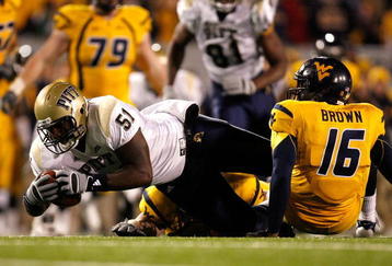 MORGANTOWN, WV - DECEMBER 1:  Defensive lineman Tommie Duhart #51 of the Pittsburgh Panthers scoops up a fumble by backup quarterback Jarrett Brown #16 of the West Virginia Mountaineers during the fourth quarter at Milan Puskar Stadium December 1, 2007 in Morgantown, West Virginia.  Pittsburgh defeated West Virginia 13-9.  (Photo by Kevin C. Cox/Getty Images)