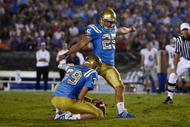 PASADENA, CA - SEPTEMBER 19:  Kai Forbath #25 of the UCLA Bruins kicks as Danny Rees #39 holds against the Kansas State Wildcats at the Rose Bowl on September 19, 2009 in Pasadena, California. UCLA defeated Kansas State 23-9.  (Photo by Jeff Gross/Getty Images)