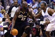 ORLANDO, FL - NOVEMBER 11:  Shaquille O'Neal #33 of the Cleveland Cavaliers looks to maneuver against Dwight Howard #12 of the Orlando Magic during the game on November 11, 2009 at Amway Arena in Orlando, Florida. NOTE TO USER: User expressly acknowledges and agrees that, by downloading and/or using this Photograph, user is consenting to the terms and conditions of the Getty Images License Agreement. (Photo by Sam Greenwood/Getty Images)