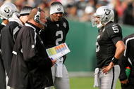 OAKLAND, CA - NOVEMBER 22: Oakland Raiders head coach Tom Cable speaks to his new starting quarterback Bruce Gradkowski #5 while newly benched quarterback JaMarcus Russell #2 looks on during their game against the Cincinnati Bengals at Oakland-Alameda County Coliseum on November 22, 2009 in Oakland, California. (Photo by Ezra Shaw/Getty Images)