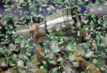 TORONTO, ON - NOVEMBER 25:  Quarterback Kerry Joseph #4 of the Saskatchewan Rough Riders hoists the trophy as confetti falls in celebration of a 23-19 victory over the Winnipeg Blue Bombers during the 95th Grey Cup on November 25, 2007 at the Rogers Centre in Toronto, Ontario, Canada.  (Photo by Harry How/Getty Images)