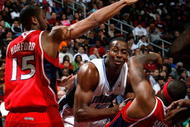 ATLANTA - NOVEMBER 26:  Al Horford #15 of the Atlanta Hawks defends as Josh Smith #5 draws a foul from Dwight Howard #12 of the Orlando Magic at Philips Arena on November 26, 2009 in Atlanta, Georgia.  (Photo by Kevin C. Cox/Getty Images)