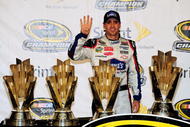 HOMESTEAD, FL - NOVEMBER 22:  Jimmie Johnson, driver of the #48 Lowe's Chevrolet, poses with all four of his championship trophies after winning the NASCAR Sprint Cup Series Championship at Homestead-Miami Speedway on November 22, 2009 in Homestead, Florida. Johnson becomes the first driver in the history of NASCAR to win four consecutive championships since the sports inception in 1949.  (Photo by Sam Greenwood/Getty Images)