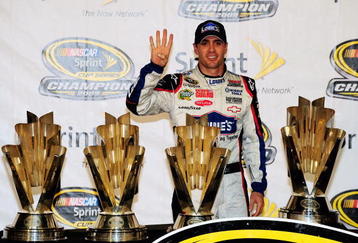 HOMESTEAD, FL - NOVEMBER 22:  Jimmie Johnson, driver of the #48 Lowe's Chevrolet, poses with all four of his championship trophies after winning the NASCAR Sprint Cup Series Championship at Homestead-Miami Speedway on November 22, 2009 in Homestead, Florida. Johnson becomes the first driver in the history of NASCAR to win four consecutive championships since the sports inception in 1949.  (Photo by Sam Greenwood/Getty Images)