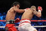 LAS VEGAS - NOVEMBER 14:  (L-R) Manny Pacquiao throws a right to the head of Miguel Cotto during their WBO welterweight title fight at the MGM Grand Garden Arena on November 14, 2009 in Las Vegas, Nevada.  (Photo by Al Bello/Getty Images)