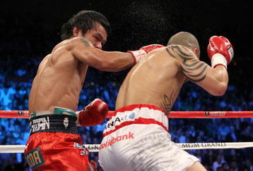 LAS VEGAS - NOVEMBER 14:  (L-R) Manny Pacquiao throws a right to the head of Miguel Cotto during their WBO welterweight title fight at the MGM Grand Garden Arena on November 14, 2009 in Las Vegas, Nevada.  (Photo by Al Bello/Getty Images)