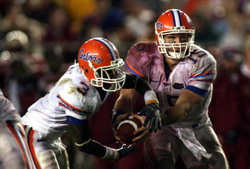 TALLAHASSEE, FL - NOVEMBER 29:  Quarterback Tim Tebow #15 of the Florida Gators hands off to running back Chris Rainey #3 against the Florida State Seminoles with teammate Jeffrey Demps #2 at Bobby Bowden Field at Doak Campbell Stadium on November 29, 2008 in Tallahassee, Florida.  Florida defeated Florida State 45-15.  (Photo by Marc Serota/Getty Images)