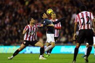 SUNDERLAND, ENGLAND - NOVEMBER 21: Lorik Cana of Sunderland battles with Carlos Vela of Arsenal during the Barclays Premier League match between Suderland and Arsenal at The Stadium of Light on November 21, 2009 in Sunderland, England.  (Photo by Laurence Griffiths/Getty Images)