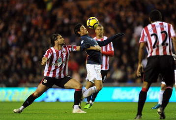 SUNDERLAND, ENGLAND - NOVEMBER 21: Lorik Cana of Sunderland battles with Carlos Vela of Arsenal during the Barclays Premier League match between Suderland and Arsenal at The Stadium of Light on November 21, 2009 in Sunderland, England.  (Photo by Laurence Griffiths/Getty Images)