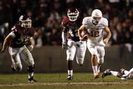 COLLEGE STATION, TX - NOVEMBER 26: Quarterback Colt McCoy #12 of the Texas Longhorns scrambles away from the Texas A&M Aggies defense to score a touchdown in the first half at Kyle Field on November 26, 2009 in College Station, Texas. (Photo by Aaron M. Sprecher/Getty Images)